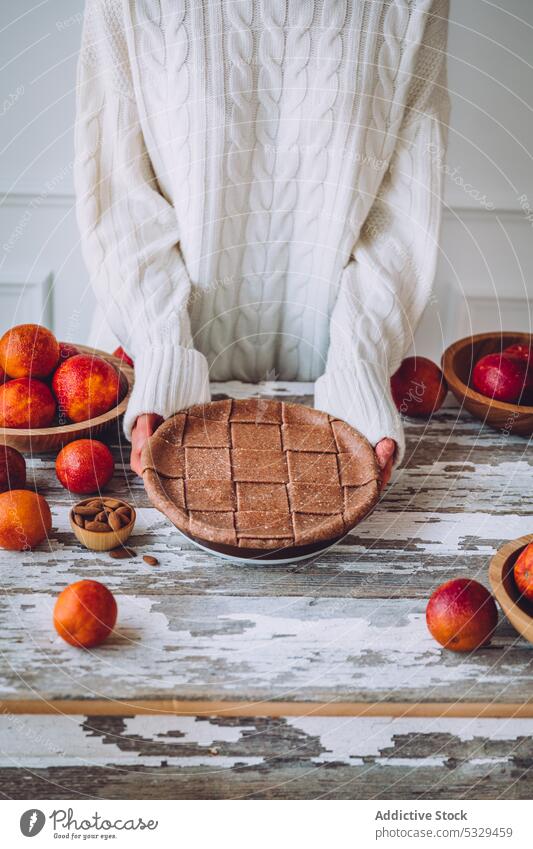 Unrecognizable person with homemade blood orange pie baked delicious fruit vegan food table eat dessert sweet tasty yummy cake pastry wooden vegan pie