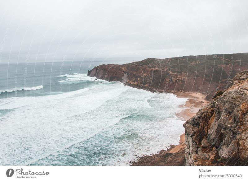 Stormy weather over the rocky cliffs of southwest Portugal's Algarve region. The power of the ocean. Wandering the Fisherman trail, Rota Vicentina splash stormy