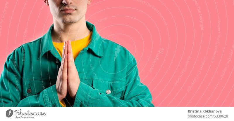 Hands of man praying, begs on pink background. Hopeful prayer asks to help with hope hands belief faith god religion young adult person please people wish