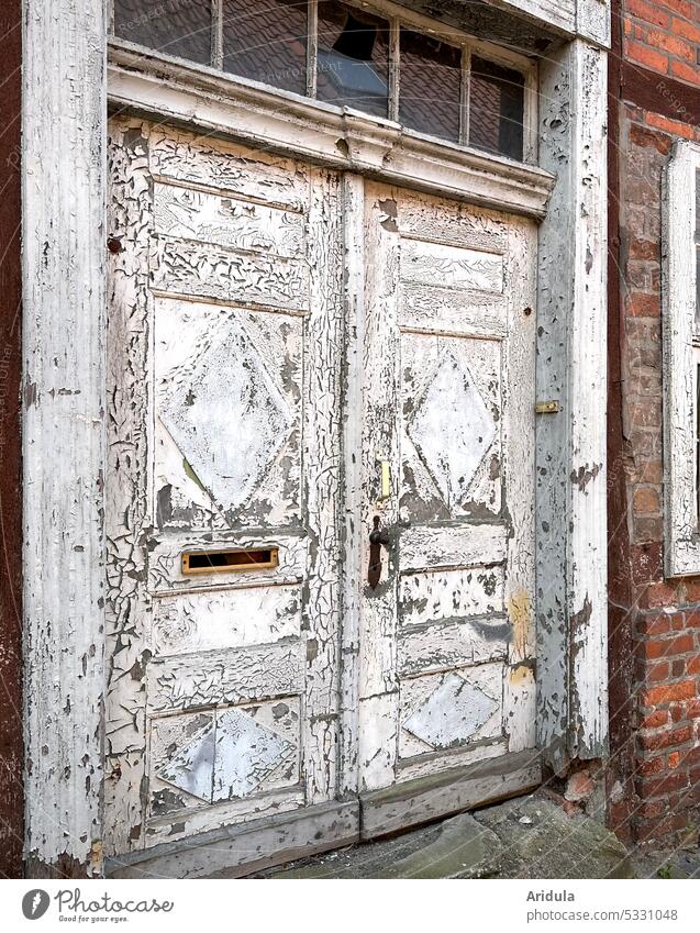 Weathered white front door with chipped paint of half-timbered house Old Varnish Colour flaking paint cracks in the varnish House (Residential Structure) Brick