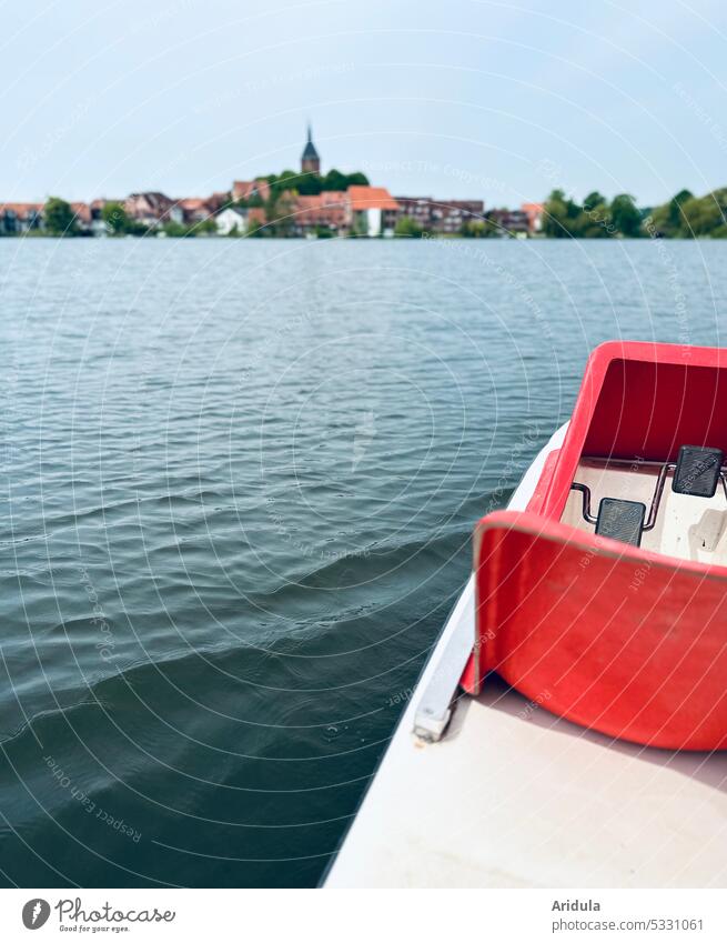Pedal boat on a lake with small town in the background No. 1 Tretbot Water Lake Waves Sun Town Church bank Hill moelln Nature Landscape Sky Beautiful weather