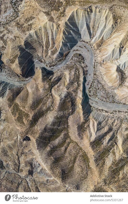 Drone view of dry rough terrain with rocky formations mountain nature landscape environment highland arid drought river scenery grass valley stone scenic