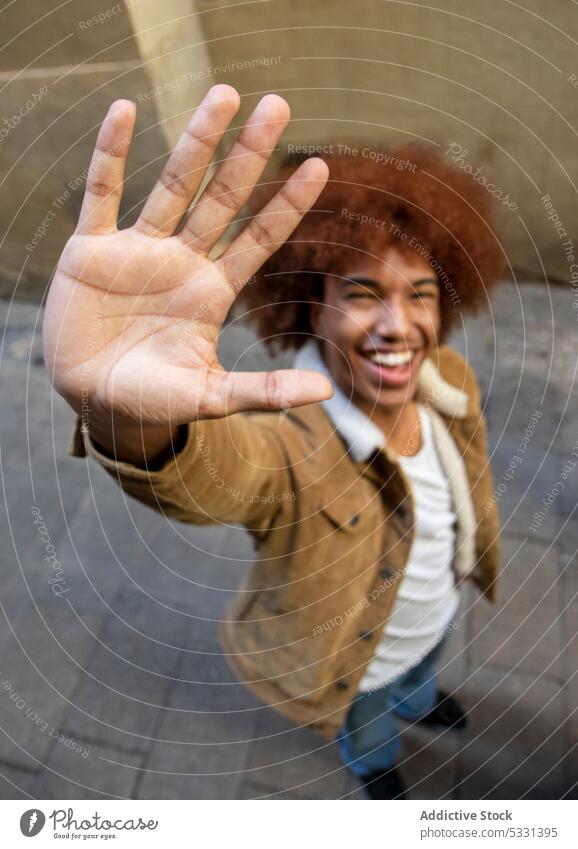 Cheerful black man showing hello gesture on street cheerful symbol smile sign appearance happy city urban male african american ethnic positive glad style