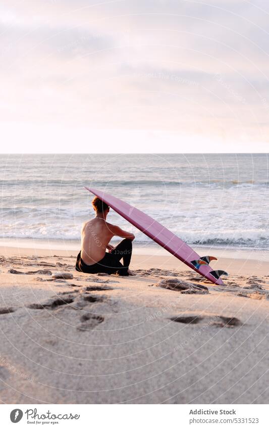 Anonymous surfer with surfboard on head resting near sea man beach sunset vacation relax summer seascape male enjoy picturesque sand shirtless coast ocean shore