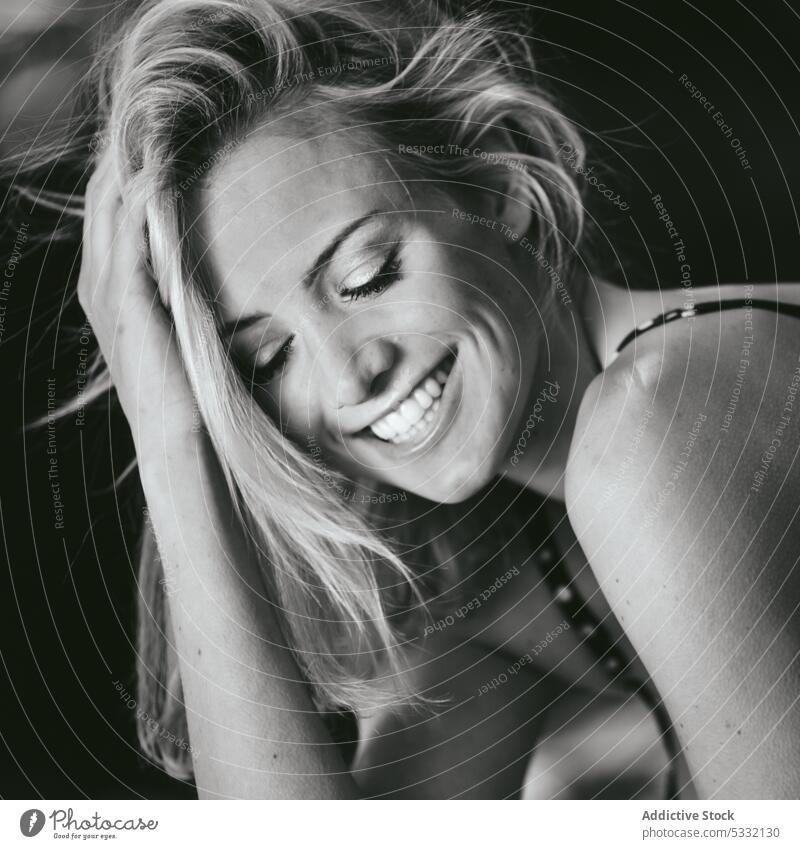 Sensual woman cheerfully laughing sensual touching hair blonde closed eyes beautiful attractive nature model female seductive style trendy excited smiling relax