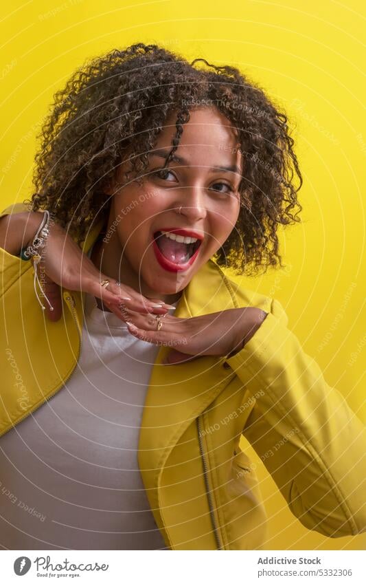 Cheerful black woman with curly hair happy smile optimist carefree cheerful positive joy expressive portrait appearance bright vivid style trendy female glad