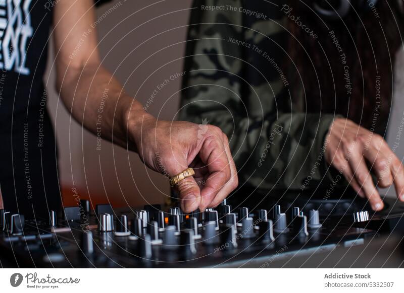 Couple of crop DJs playing music couple dj console sound equipment mix create audio controller panel electronic contemporary modern button occupation work skill