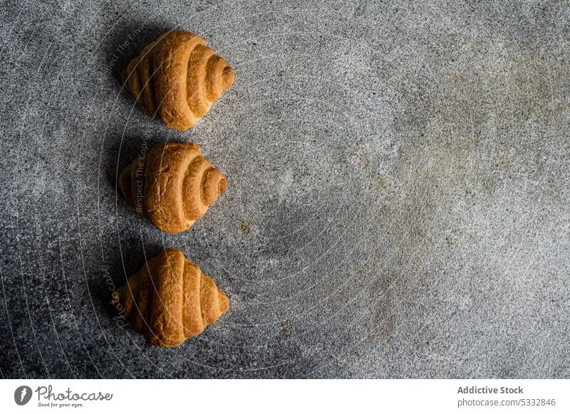 Fresh baked croissants breakfast food background concrete crusty eat eating european french fresh gourmet meal pastry row served sweet table dessert bakery
