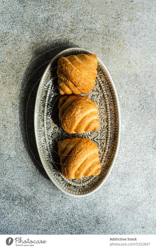 Fresh baked croissants breakfast food dish background concrete crusty eat eating european french fresh gourmet meal pastry row served sweet table dessert bakery