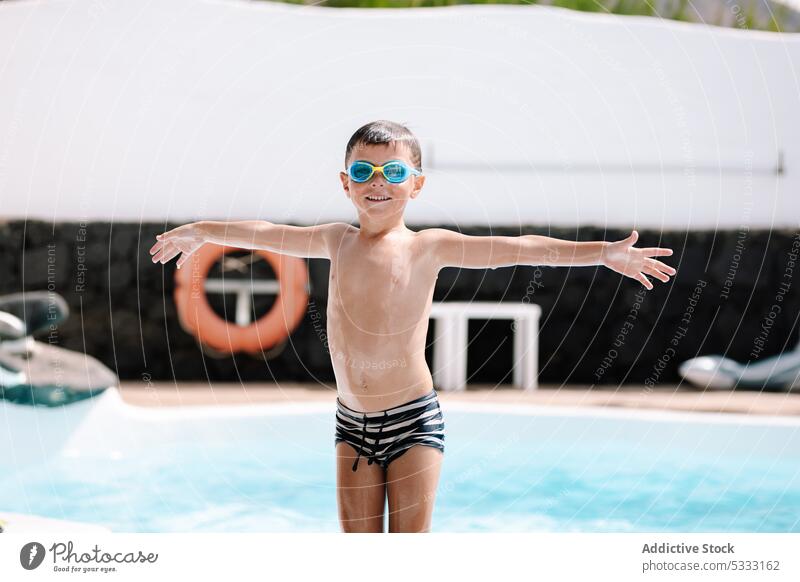 Happy little boy in swimming pool kid happy enjoy cheerful vacation outstretch smile positive optimist dive goggles swimwear holiday child water carefree
