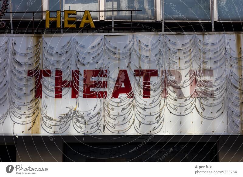 Playing time over Theatre Facade Building neon advertisement Old Exterior shot Town Day Manmade structures Deserted publicity Ravages of time Broken Derelict