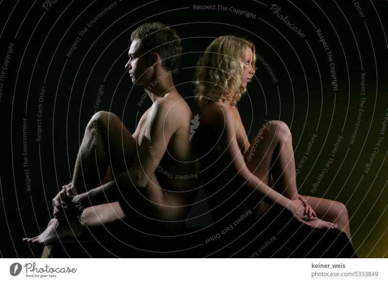 A man and a woman sit naked back to back and wonder where physical love has gone. No sex - no fun. Man Woman Naked nudity Opposite Sexuality relation Couple