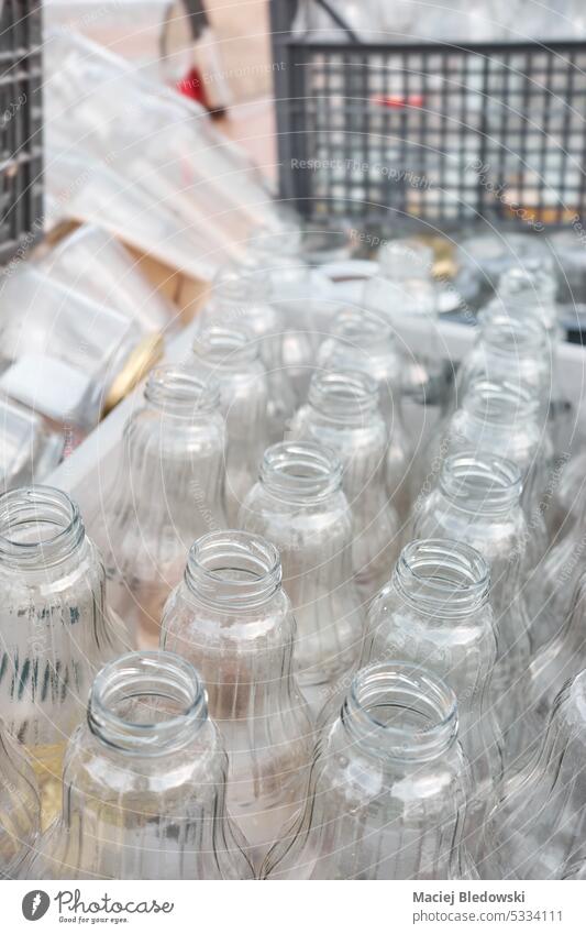 Used empty glass bottles stored in containers for recycling, selective focus. dirty waste drink recycle used garbage industry environment many reuse outdoors