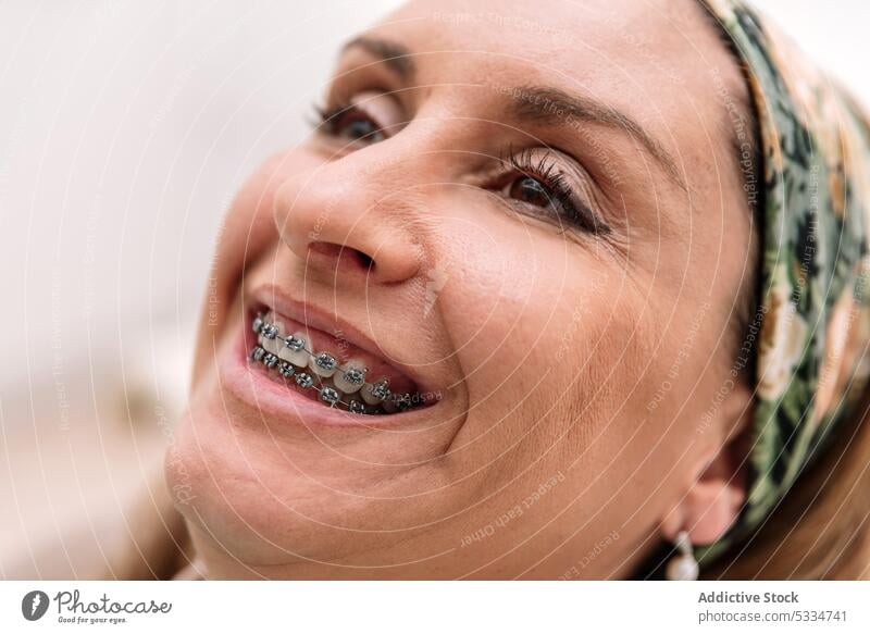 Smiling female patient in headscarf wearing braces woman dental procedure smile treat happy teeth positive optimist cheerful clinic oral glad stomatology
