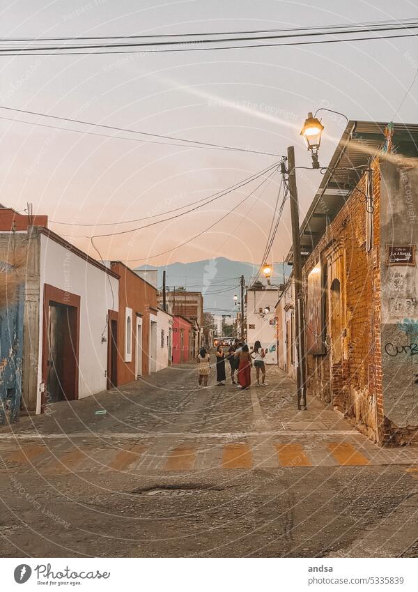 Sunset in a small village in Central America Village Indigenous Group Latin American Oaxaca Mexico Paving stone Street Mountains in the background mountains