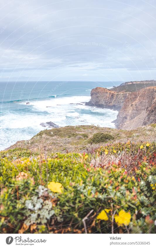 Portugal's western coastline of rocky cliffs and sandy beaches in the Odemira region. Wandering along the Fisherman trail on rainy days point horizon solitude