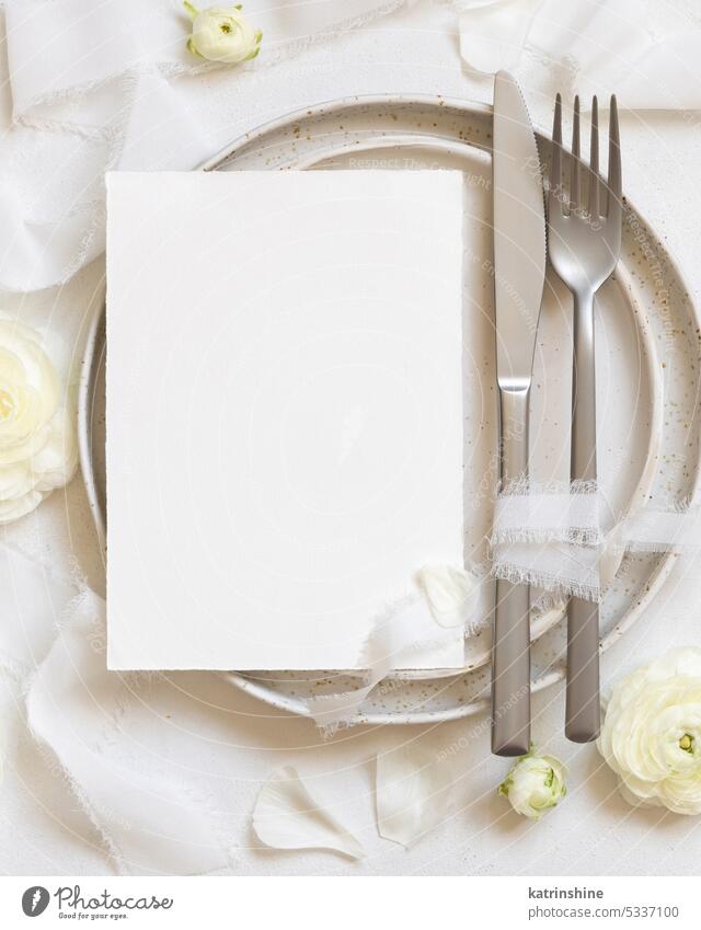 Wedding table setting with card near cream roses and white silk ribbons top view, mockup WEDDING flowers romantic envelope table place menu plate fork knife