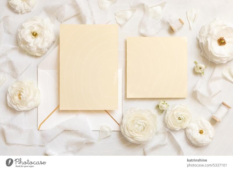 Blank cards and envelopes near cream roses and white ribbons top view, wedding mockup WEDDING flowers romantic silk paper valentine spring mothers day above