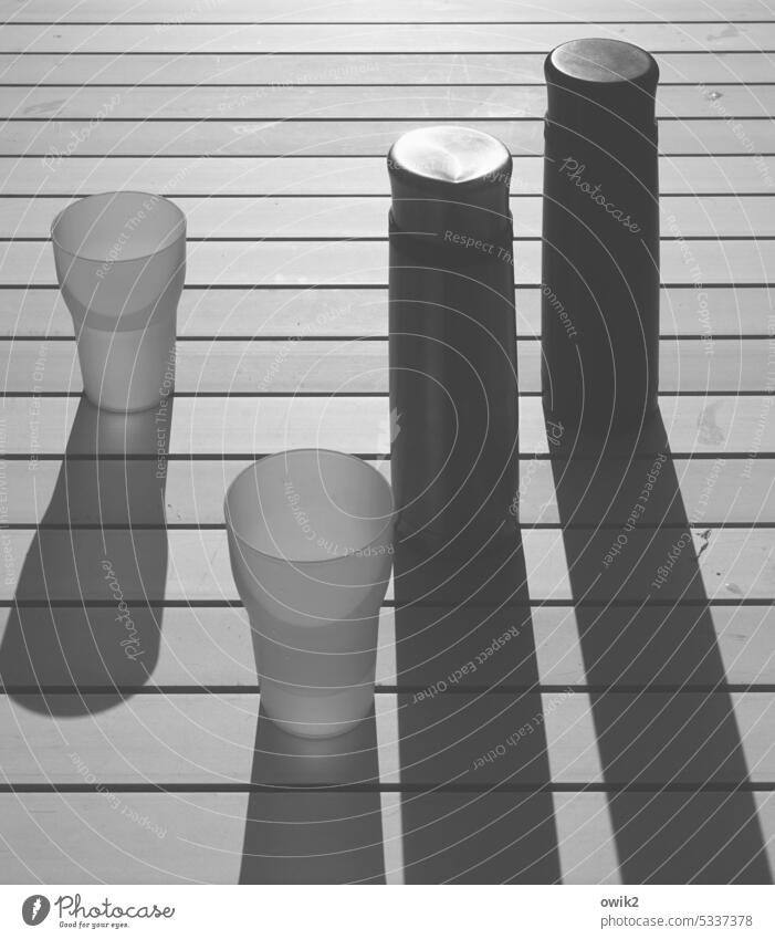 The Dark Side of the Thermos Thermoses Plastic cup Garden table Sunlight Shadow Black & white photo Mug lines Detail Design Exterior shot Contrast Metal factual