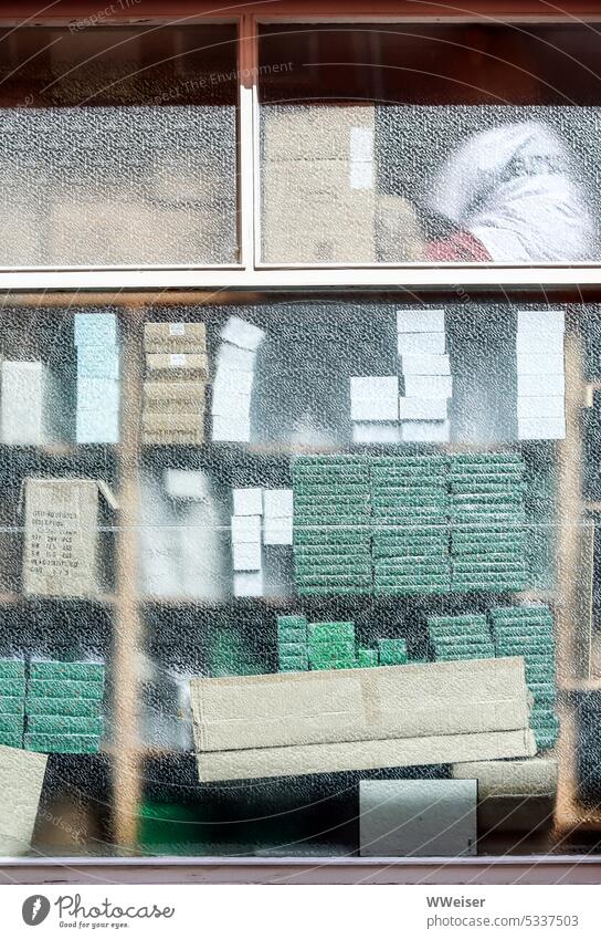 Behind the window you can see stacks of boxes and notebooks in muted colors Window Glass Stack Shelves stacked Stationery Notebooks Paper paperboard cartons