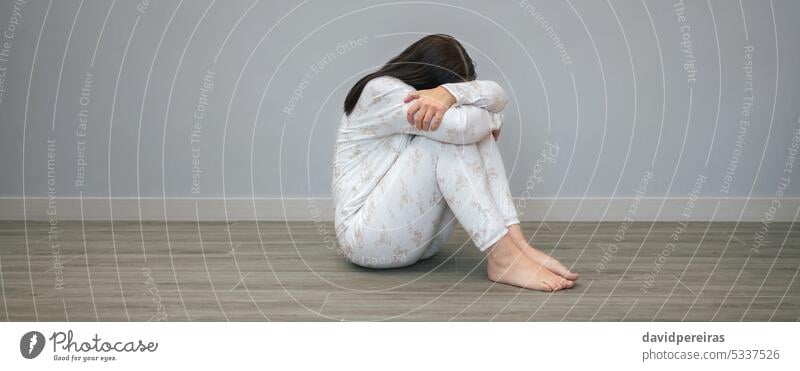 Woman with mental disorder and suicidal thoughts crying unrecognizable woman health desperate suicide sitting floor panorama web header banner panoramic copy