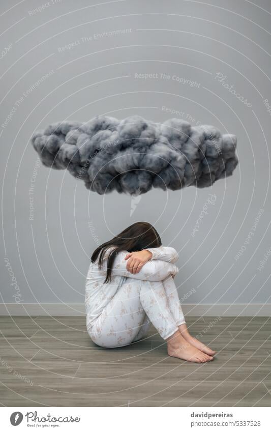 Woman with mental disorder and suicidal thoughts crying under a dark storm cloud unrecognizable woman suicide health desperate sitting floor concept conceptual