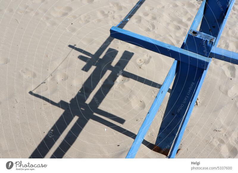Wooden frame with shadow in sand Framework Wooden rack Sand Beach Light Shadow shadow cast Contrast Structures and shapes Sunlight Pattern Exterior shot