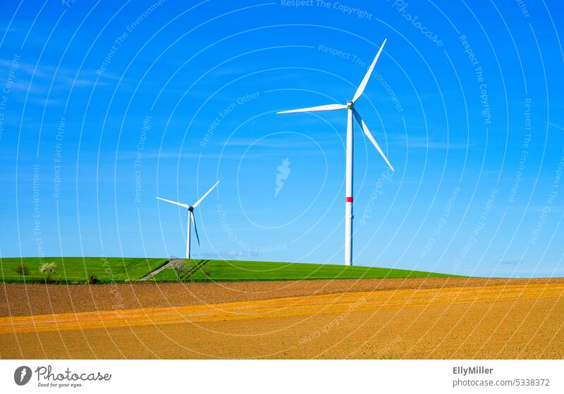 Environmentally friendly wind energy. Wind turbines at the edge of the field. wind power Pinwheel windmills Wind energy plant Renewable energy Energy industry