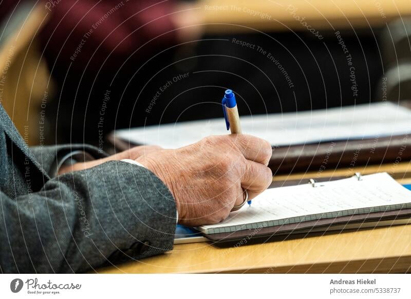 Seminar - Transcript with pen and paper Lecture price Paper Hand Old Man masculine crease Skin notes Notebook university University Teacher teaching event