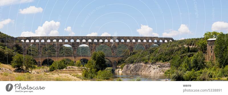the old Roman aqueduct Pont Du Gard near Nimes in France across the river Gardon seen from the west side H2O Liquid Panurama Unesco World Heritage copy space