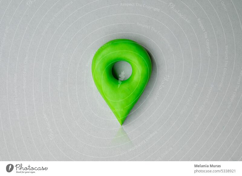 Green location symbol of pin on blue background, 3d GPS pin icon made of plasticine, location concept. abstract address button cartography color design