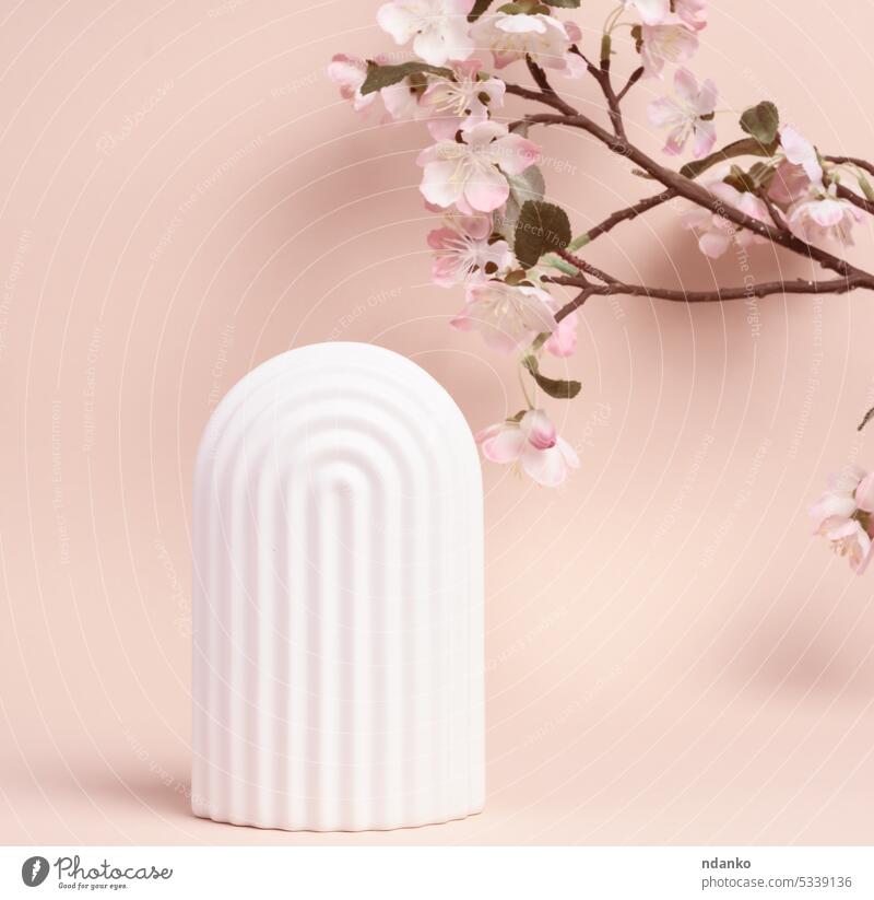 Podium with white arches to showcase cosmetics, products and other merchandise advertising backdrop background beige blank branch cosmetology decoration design
