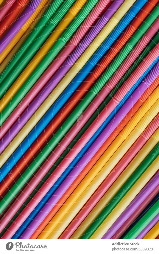 Bunch of colorful straws plastic texture bunch pipe beverage object art cocktail detail swirl bright vivid rainbow orange blue red yellow green pink purple