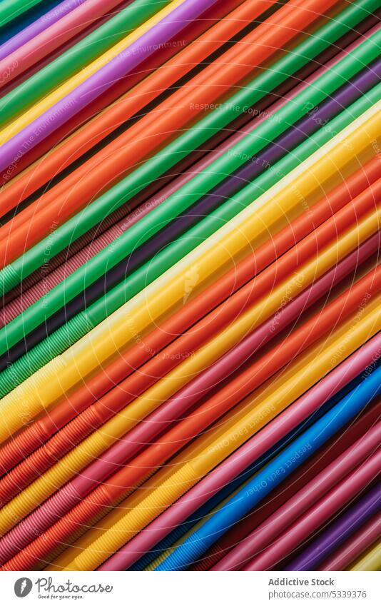 Bunch of colorful straws plastic texture bunch pipe beverage object art cocktail detail swirl bright vivid rainbow orange blue red yellow green pink purple