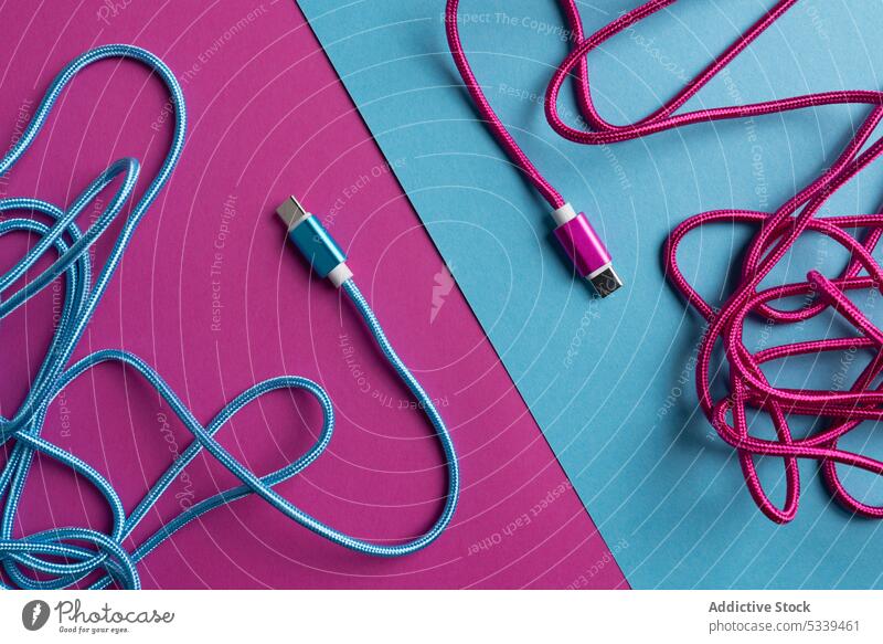 Multicolored USB cables on bright background usb colorful blocking opposite equipment technology neon blue pink design connection vibrant vivid plug supply
