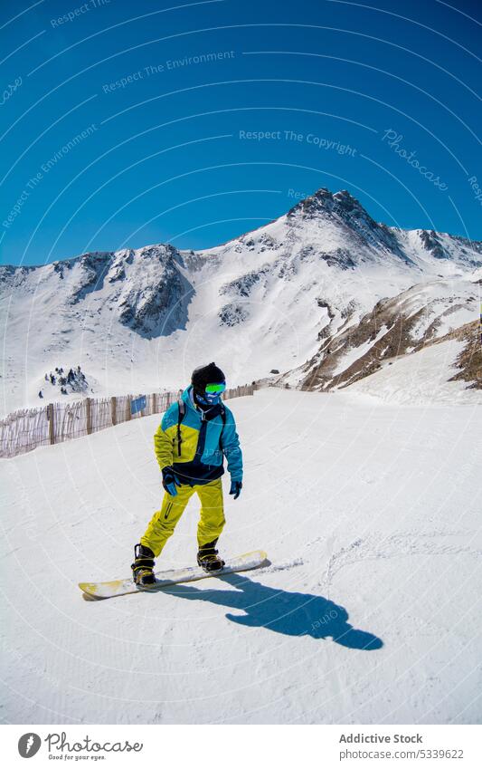 Unrecognizable snowboarder on snowy mountain slope winter sport activity person nature vacation enjoy season resort cold recreation holiday weather ridge travel