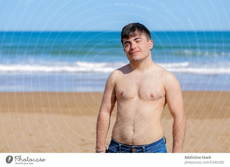 Glad shirtless gay on beach man transgender sunbath sand sea topless male lgbt lgbtq homosexual transsexual androgynous queer pride equal rights tolerance
