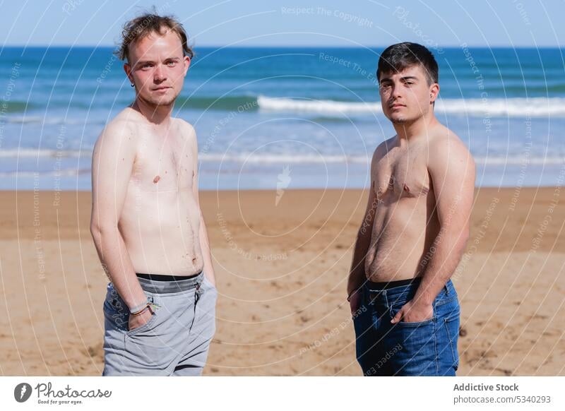 Unemotional gay couple on sea shore men transgender partner beach ocean male lgbt lgbtq homosexual pride transsexual androgynous queer equal unemotional liberty