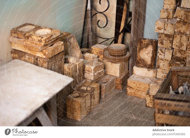Old wooden blocks in workshop grunge mold pottery clay earthenware shabby weathered dirty professional tool craft rough industry equipment timber aged lumber