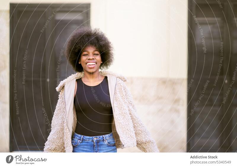 Happy ethnic young female with Afro hairstyle woman smile afro happy portrait positive cheerful glad long hair cozy optimist appearance lady toothy smile joy