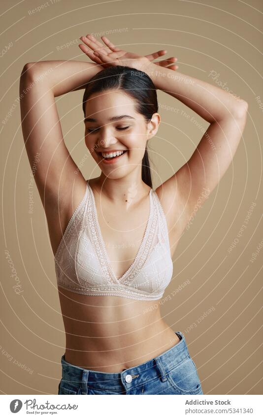 Cheerful woman in underwear smiling with closed eyes - a Royalty