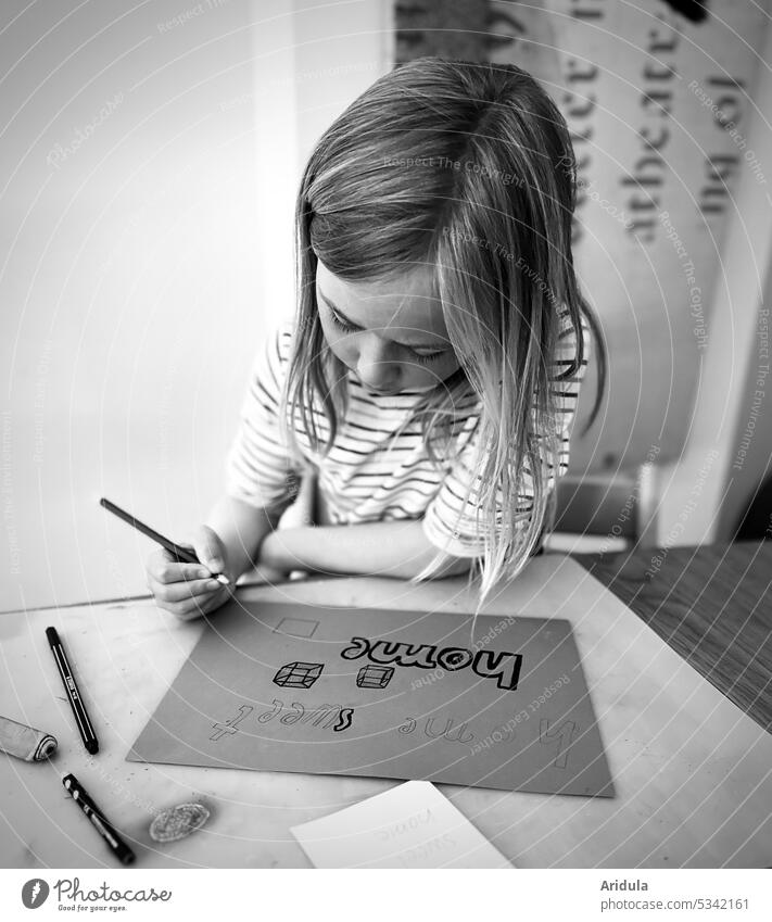 "home sweet home" | child sitting at table writing and drawing b/w No. 3 Child Write Draw Paper Table at home Infancy pen Pen posture Posture hair Head Sit