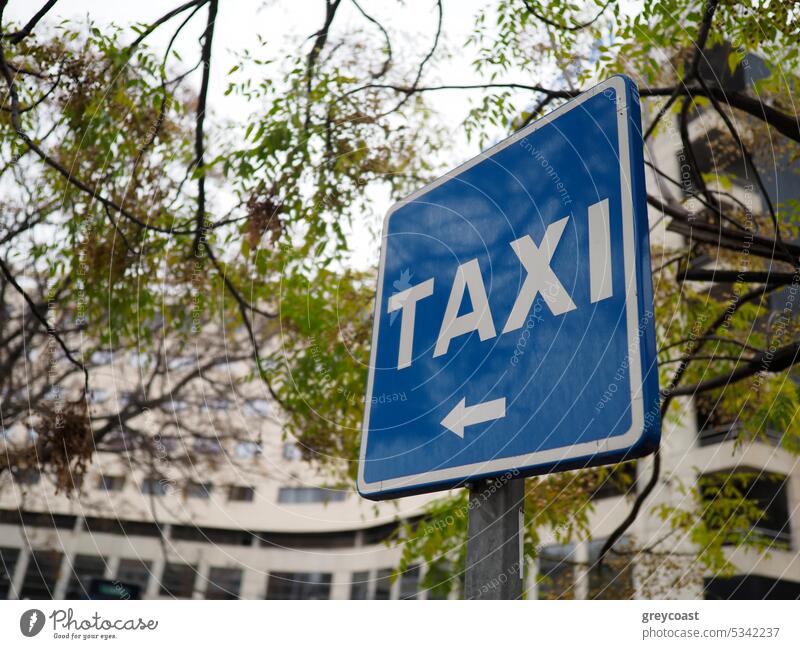 Taxi sign on street taxi symbol spain city traffic transport service urban blue outdoor information text nobody town post arrow signage roadsign road sign color
