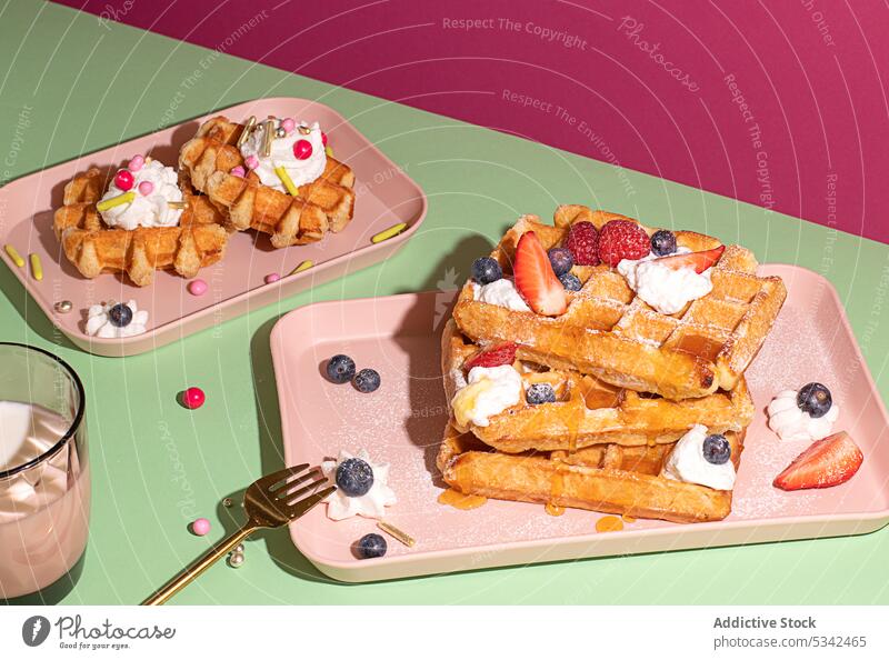 Waffles garnish with raspberry and blueberries waffle breakfast bakery blueberry homemade morning drink fruit colorful fork strawberry traditional