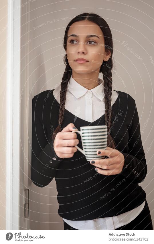 Portrait of stunning classy concentrated young female coffee door style cup confident thoughtful hot drink pensive gothic hispanic black color monochrome modern
