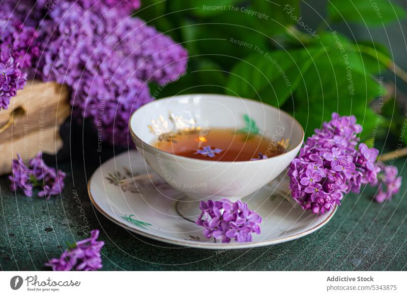 Front view of tasty black tea in vintage cup on mint green concrete table aromatic beverage bloom blossom bouquet box cement colorcup colorful cutlery dark