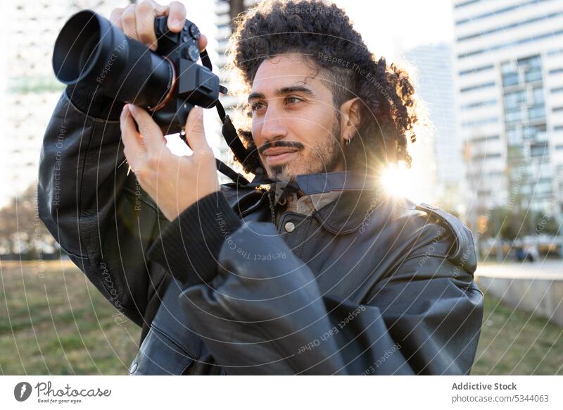 Photographer taking picture on photo camera man take photo photographer street photography capture memory shoot city hobby ethnic male professional black