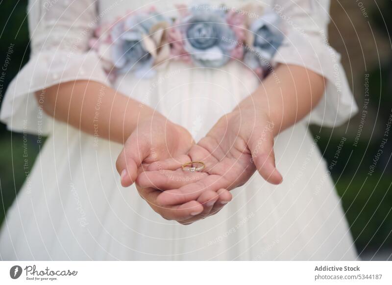 Unrecognizable girl with wedding ring in hands ceremony bearer show bride event marriage demonstrate child celebrate floral kid elegant occasion festive holiday
