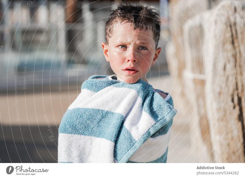 Cute boy in towel on poolside resort summer vacation holiday child fence kid tropical calm rest recreation sun weekend wrap wooden summertime childhood tourism