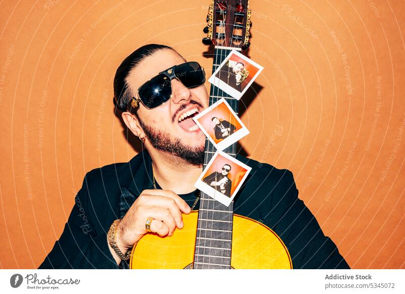 Man with acoustic guitar in studio man hipster style musician guitarist trendy sunglasses male beard individuality confident hobby calm appearance modern cool